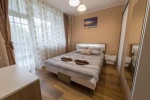 a bedroom with a bed with two towels on it at Marvelous Riverside Flat in Ruse