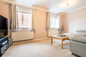 a living room with a couch and a coffee table at Bulkington Lodge Coventry - Affordable Cosy Double & En-Suite Rooms in Bulkington