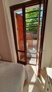 a bedroom with a door open to a patio at BeB I PORTICI in Cernobbio