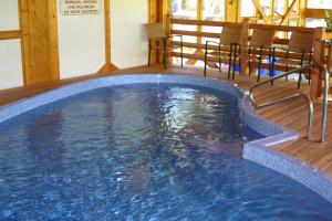 a large swimming pool in the middle of a room at Hotel Ennskraxblick in Kleinarl