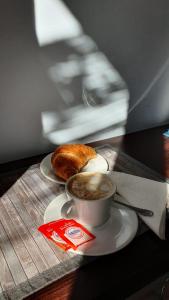 a cup of coffee and a pastry on a table at BeB I PORTICI in Cernobbio