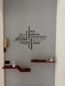 a bathroom with a wall with words on it at BeB I PORTICI in Cernobbio