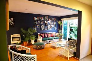 a living room with a couch and chairs at Luxurious Mid Century Modern folk art home in Mexico City