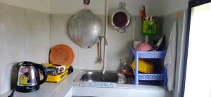 a miniature kitchen with a sink and a utensil at Homestay 1-2pax AC room 5 including private kitchen in Siem Reap