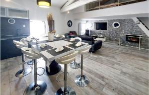 a kitchen and living room with a table and chairs at 4 Bedroom Awesome Home In Villars in Villars