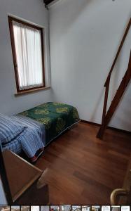 a bedroom with a bed in the corner of a room at Casa Adige in Verona