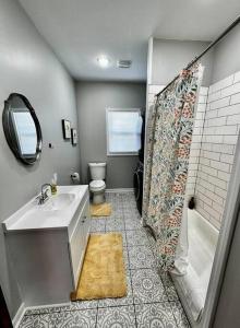 a bathroom with a sink and a shower and a toilet at Mrs. Hughes Cottage - 2 bedroom House w/ parking in Hamilton