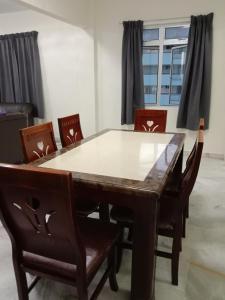 a dining room with a table and chairs at Colobeentoi Three Bedroom Sea View in Port Dickson