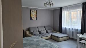 a living room with a couch and a table at Central Park in Daugavpils