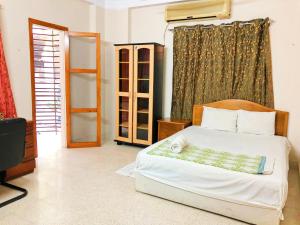 a bedroom with a bed and a window at Maya Eco Apartment Service in Dhaka