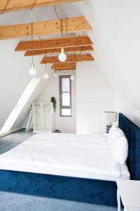 a large bed in a room with a blue couch at Space Apartments Old Town - River View in Szczecin