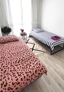 a bedroom with two beds with leopard print sheets at Bel appartement entre Disney Land et Paris in Chelles