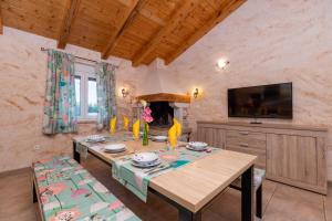 a dining room with a table and a fireplace at Villa Stari Punat in Sveti Petar u Šumi