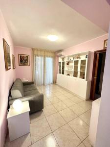a living room with a couch and a table at Appartamento al centro di Pula in Pula +19 photos