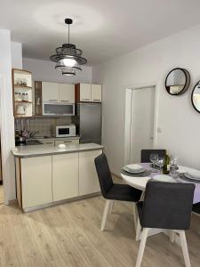 a kitchen and dining room with a table and chairs at Apartments Lovro in Lovran