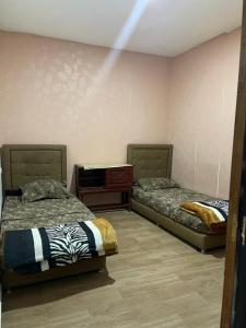 two beds sitting in a room with at coin du repos in Oujda