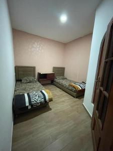 a room with two beds in a room at coin du repos in Oujda