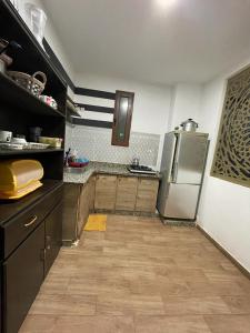a kitchen with a refrigerator and wooden cabinets at coin du repos in Oujda