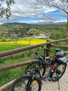a bike parked next to a fence with a field at Casale Terre Rosse in Saturnia