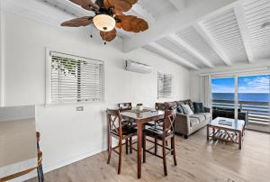 a dining room with a table and a couch at Sleepy Hollow Villas #2 in Laguna Beach in Laguna Beach
