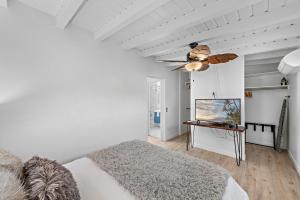 a bedroom with a bed and a ceiling fan at Sleepy Hollow Villas #2 in Laguna Beach in Laguna Beach