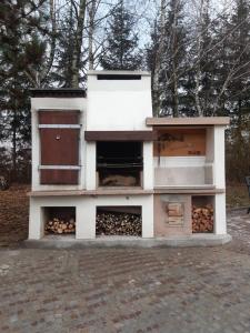 a building with a pile of fire wood in it at Rezydencja Pod Platanem 