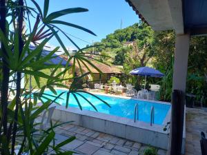 a view of a swimming pool from a resort at Pousada do Sossego Conceição de Jacareí in Mangaratiba