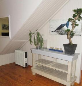 a staircase with a white table with a tree in a room at JBay Surfed Out in Jeffreys Bay