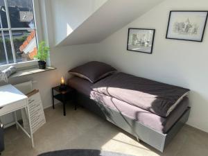 a small bedroom with a bed in a room at Ferienwohnung Westerwaldblick Haiger in Haiger