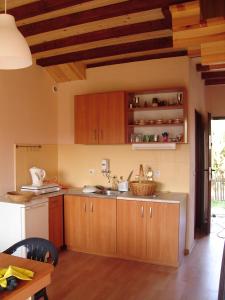 a kitchen with wooden cabinets and a counter top at apartamenty-domy in Lubiatowo +18 photos