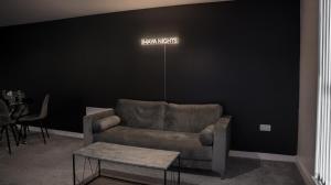 a living room with a couch and a table at A spacious 2 bed with a river and cascade view, Imaya Nights, M3 in Manchester