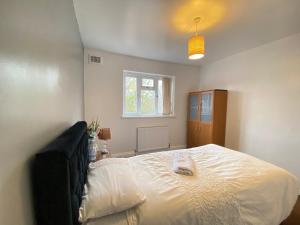 1 dormitorio con 1 cama blanca grande y ventana en budget private rooms close to city centre and airport en Birmingham