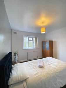 a bedroom with a large white bed with a window at budget private rooms close to city centre and airport in Birmingham