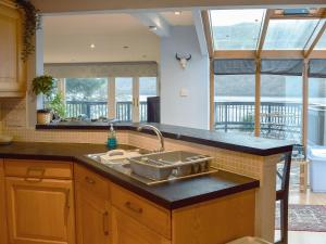 a kitchen with a sink and a counter top at March Cottage in Arrochar