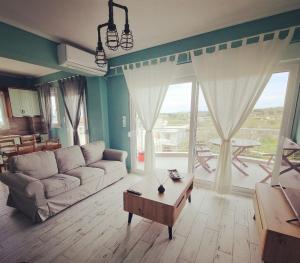 a living room with a couch and a coffee table at Tararas apartments in Nea Michaniona
