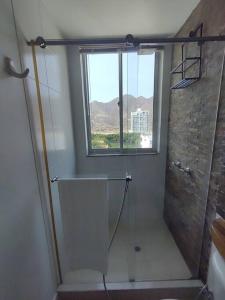 a bathroom with a shower and a window at Hugos studio loft in Gaira
