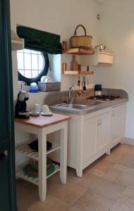 a kitchen with a sink and a counter top at Tenuta alla Castellana in Gallipoli