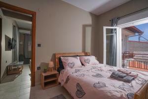 a bedroom with a bed and a balcony at Bridge Brazen in Edessa
