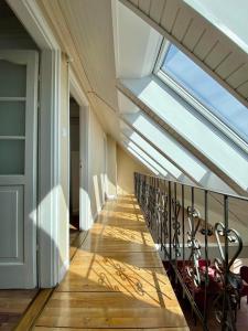 a balcony with a skylight in a house at DONATICOEUR Bellevue in Budapest