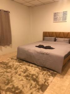 a bedroom with a large bed with a rug at Tara Kan Resort in Ban Nong Hin