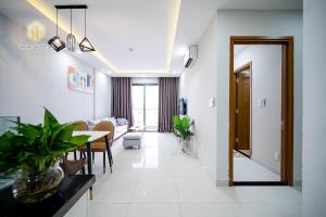 a living room with a table and a dining room at Cozy Apartment in District 4-City Center - Free Netflix - canhogiatot24h in Ho Chi Minh City