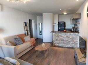 a living room with a couch and a fireplace at Appartement sur le port Résidence Marina Palmu in Porto-Vecchio +6 photos