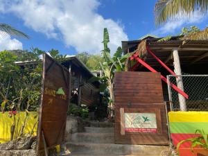 een klein huis met een trap daarheen bij Villa Rasta - Ocean View Bungalows in Port Antonio