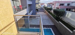 a balcony of a building with a swimming pool at Terraços da Baía - São Martinho do Porto in São Martinho do Porto