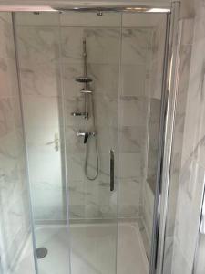 La salle de bains est pourvue d'une douche avec une porte en verre. dans l'établissement Chez Jessica, à Chaumont-sur-Loire