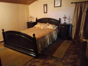 a bedroom with a large bed and a dresser at appartement chalet in Imouzzer Kandar