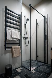a bathroom with a shower with a glass door at Edinburgh loft-style apartment in Jūrmala