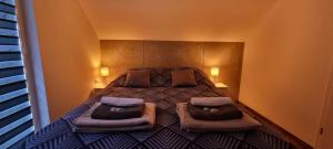 a bedroom with a bed with two pillows on it at Luxury Apartments Bernardyńska Domek 1 , 2 in Kielce