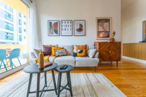 a living room with a couch and two tables at FLH Funchal Urban Escape Flat in Funchal