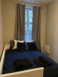 a bedroom with a large blue bed with a window at 4 bedroom flat in the heart of Oslo in Oslo